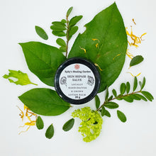 Load image into Gallery viewer, "Skin Repair Salve" tub with leaves surrounding it.