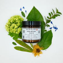 Load image into Gallery viewer, "Skin Repair Salve" tub with leaves surrounding it.