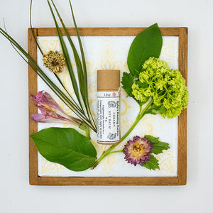 Eye Balm product surrounded by flowers.